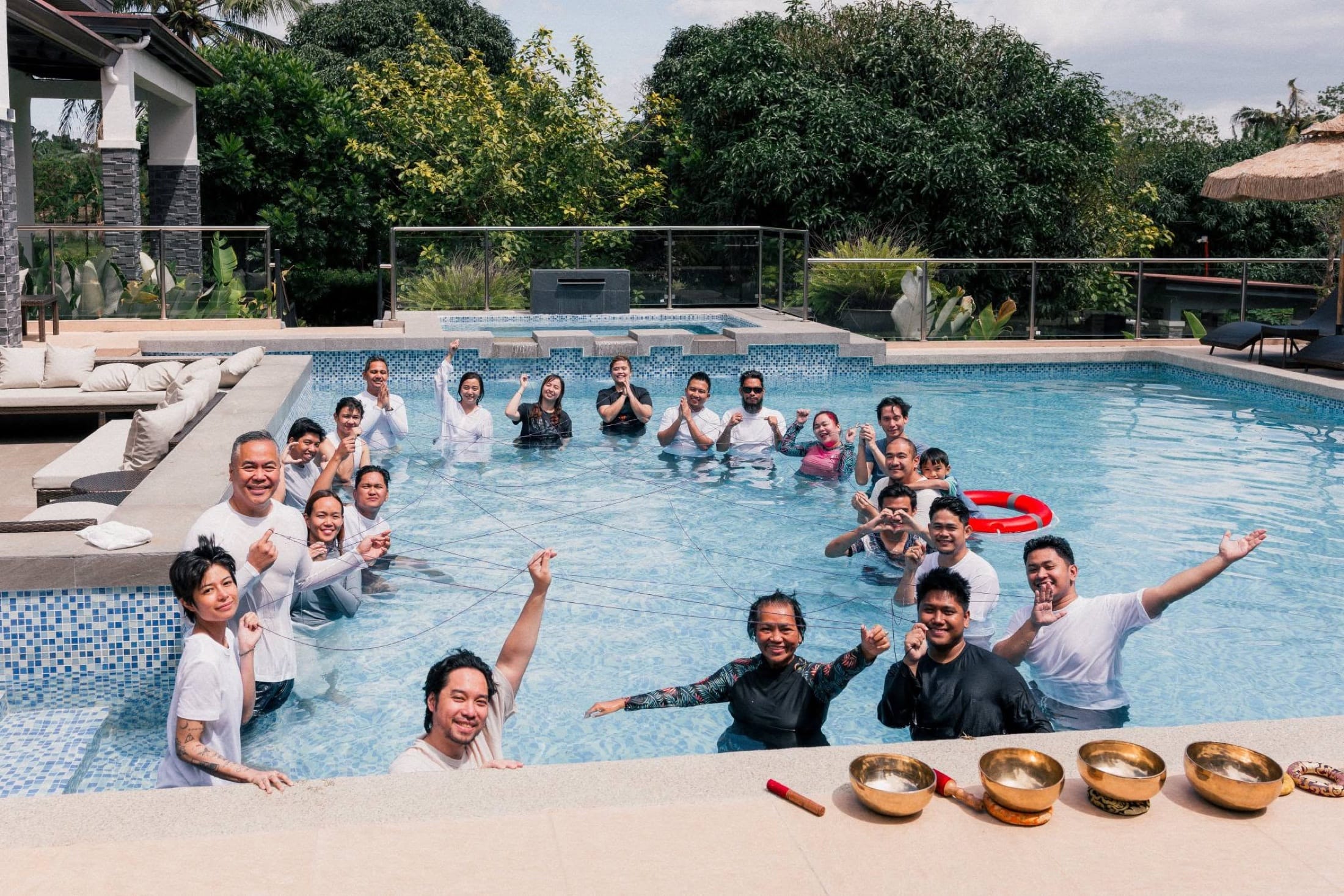 The whole retreat community gathered together in the pool, arms raised in celebration