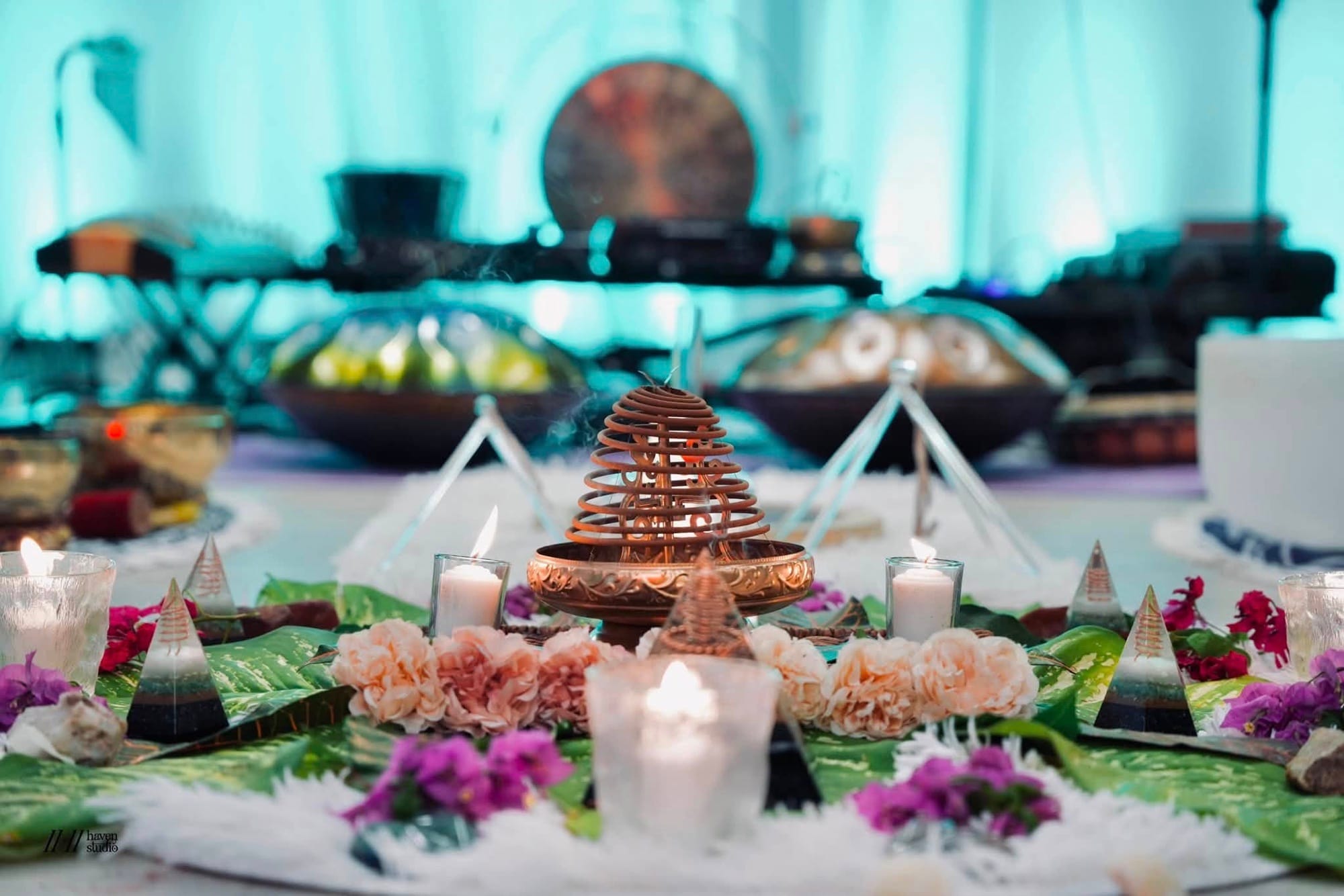 A close detail of the copper incense burner, candles, and fresh flowers on the altar